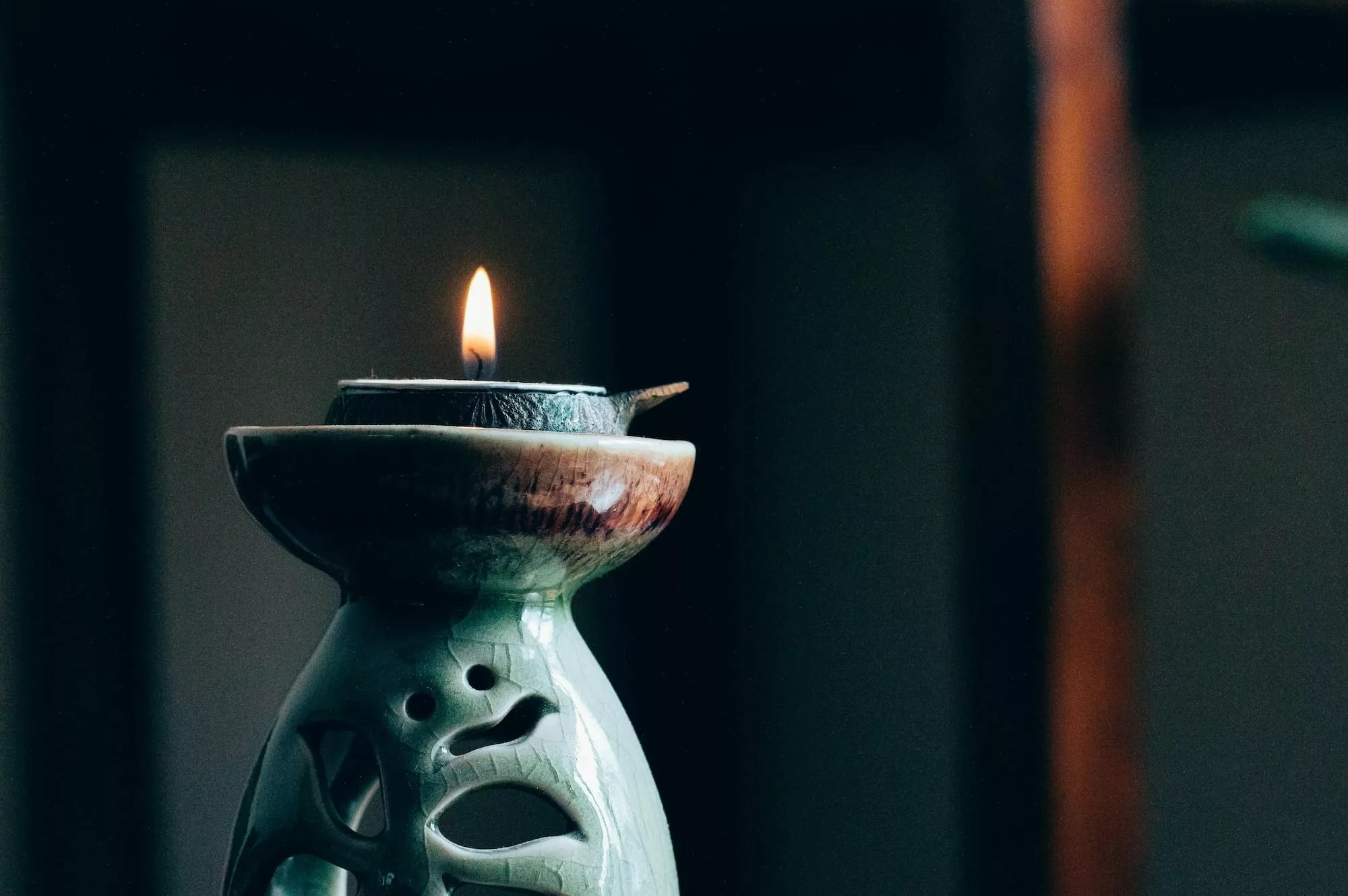 A candle on a desk.